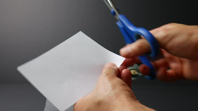 Scissors cutting white paper, hand movement, scissor in hand cutting paper, cut tool, sharp equipment shaping