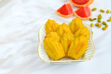 Pistachio grapefruit Madeleine on white background