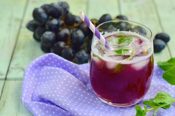 Grape mint soda mocktail with fresh grapes background