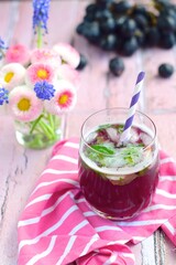 Grape mint soda mocktail with fresh grapes background