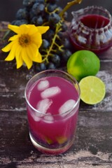 Grape mint lime soda mocktail with fresh grapes background