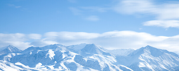 panoramic view of snowy mountains and clouds