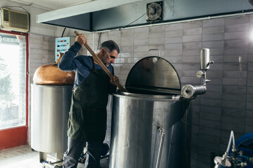man working in craft mini brewery