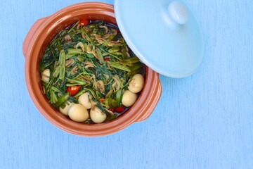 Stir fried Water Spinach or Kangkung with fried Anchovies and Quail eggs. Indonesian cuisine. Flat lay