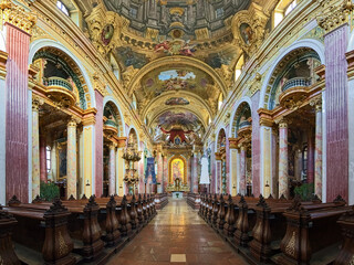 Fototapeta na wymiar Vienna, Austria. Interior of Jesuit Church or University Church. The church was built in 1623-1627. It was remodeled in 1703-1705 by Andrea Pozzo, who also executed the large ceiling fresco.