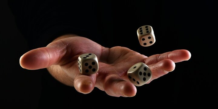 Female hand throwing dice in the air on black background. Fortune concept playing dice. luck concept. lucky man