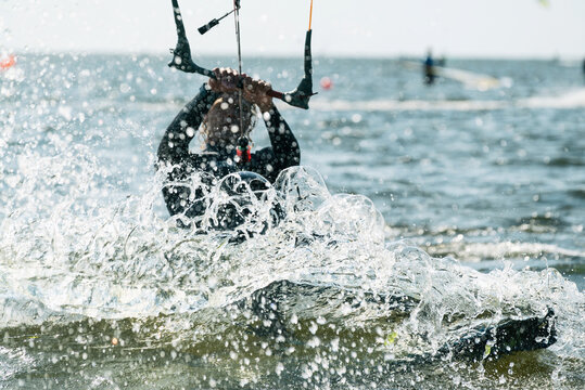 People swim in the sea on a kiteboard or kitesurfing. Summer sport learning how to kitesurf. Kite surfing on Puck bay in Jastarnia, Poland
