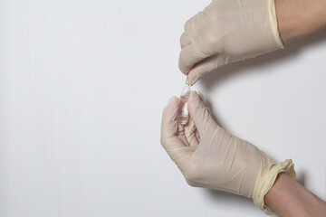 Doctor filling syringe with medication, closeup. Vaccination and immunization