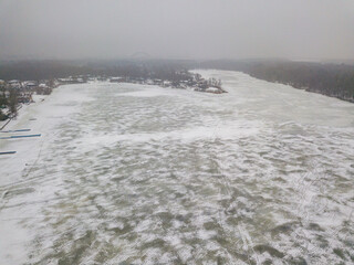 Frosty patterns on ice. Aerial drone view. Foggy winter morning.