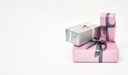 International Womens Day Gifts and Presents. Three colorful wrapped gift boxes with bows against white background