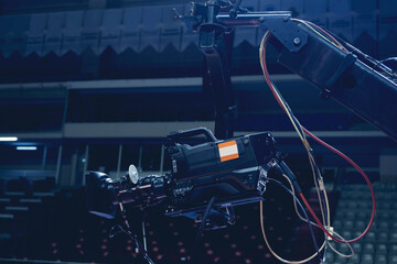 TV camera of a crane on a football mach or concert