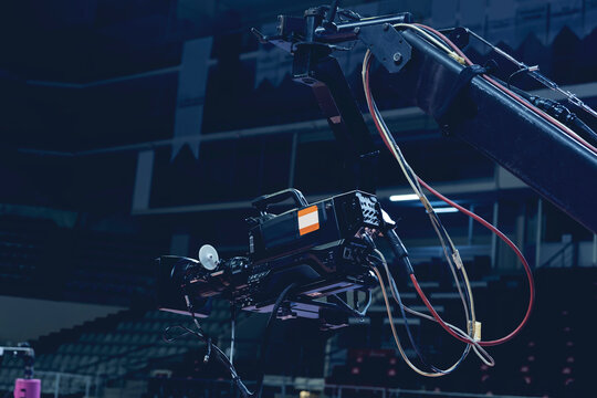 TV camera of a crane on a football mach or concert