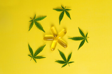 Fototapeta na wymiar Marijuana oil, fresh leaves. Cannabis plant on yellow background. Hemp recreation, medical usage, legalization.