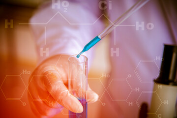 Scientists are carrying test tubes containing blue chemicals in the laboratory to research learning concepts to draw new knowledge.