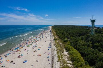 Sunbathing on the beach by the sea. Aerial drone view of  Baltic Sea coast in Hel peninsula, Jastarnia. Puck Bay in Poland