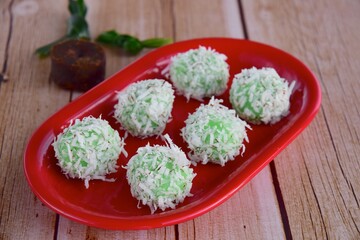 Indonesian Cuisine, Klepon or Traditional Pandanus Rice Balls Made From Glutinous Flour and Grated Coconut with Palm sugar Filling