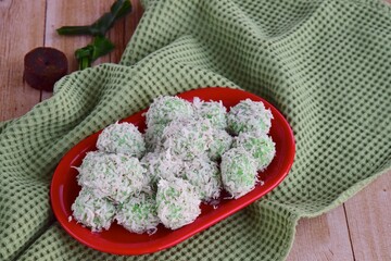 Indonesian Cuisine, Klepon or Traditional Pandanus Rice Balls Made From Glutinous Flour and Grated Coconut with Palm sugar Filling