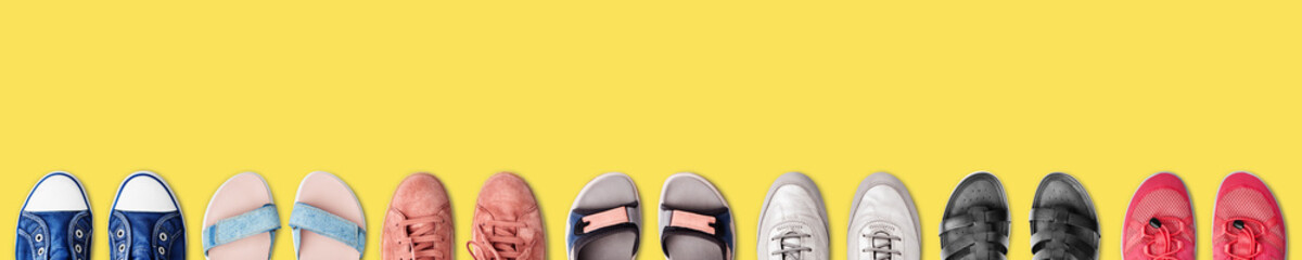 Colorful female shoes collection yellow background close up top view, women fashion sneakers,...