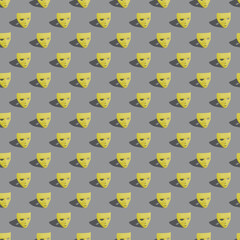 Seamless creative pattern layout made with Illuminating Yellow color Carnival masks on Ultimate Gray background. Mardi Gras or Carnival mask concept. Trendy colors of the year 2021. Flat lay.