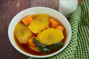 Indonesian Food, Kolak Pisang Ubi or Banana Sweet Potato Compote. Made from Plantain Banana cooked with coconut milk, palm sugar and pandanus leaves. Popular dessert during Ramadan