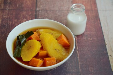 Indonesian Food, Kolak Pisang Ubi or Banana Sweet Potato Compote. Made from Plantain Banana cooked with coconut milk, palm sugar and pandanus leaves. Popular dessert during Ramadan