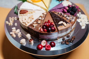 Several cakes are symmetrically laid out on a metal plate. Food delivery. Homemade baking. close up.