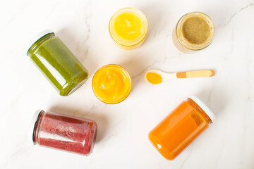 Three jars of baby food on white background