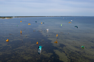 People swim in the sea on a kiteboard or kitesurfing. Summer sport learning how to kitesurf. Kite...