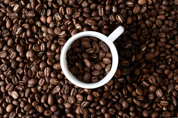 White cup and coffee beans. Closeup view