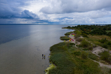 Aerial drone view of  Baltic Sea coast in Hel peninsula, Jastarnia. Drak clouds by the Puck Bay in...