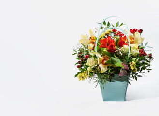 delicate orchids in a gift box or basket on a light background. bouquet of orchids, roses and chrysanthemums.