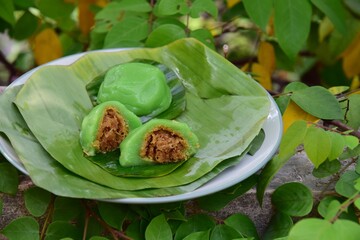 Kue Bugis, Indonesian jajan pasar, traditional snack of glutinous rice flour cake filled with sweet grated coconut, underlined with banana leaf. Popular snack during Ramadan as Takjil