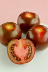 Fresh and organic kumato tomatoes on a plate. 