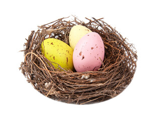 Colorful eggs in wooden bird nest isolated on the white background