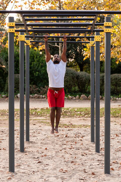 african american athlete doing fitness exercises on bars, calisthenics workout.