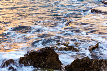 Blurred abstract natural background of sea water with waves and foam. Motion blur. Nature. 