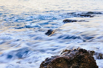 Blurred abstract natural background of sea water with waves and foam. Motion blur. Nature. 