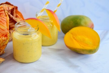 Fresh mango smoothie in glass with chia seeds