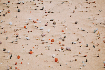 Stones and pebbles in the sea sand