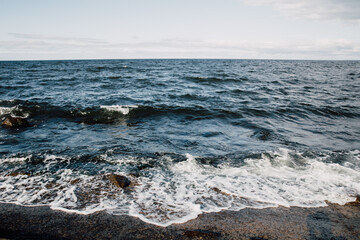 Marine Landscape of dark blue sea, waves and rocks