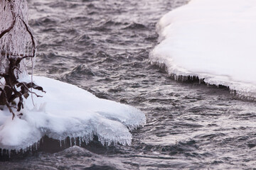 Beautiful ice formations over a mountain river, close up.