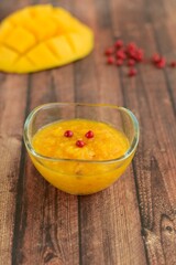 Mango pink peppercorn dressing on wooden background