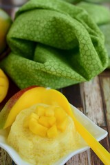 Mango pudding with cubed fresh mango on top