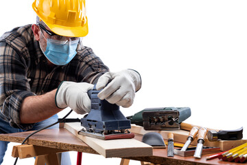 Carpenter worker at work isolated on white background, wears helmet, goggles, leather gloves and surgical mask to prevent coronavirus infection. Preventing Pandemic Covid-19 at the workplace.