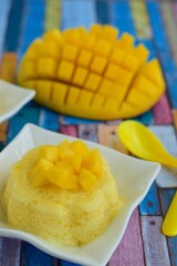 Mango pudding with cubed fresh mango on top