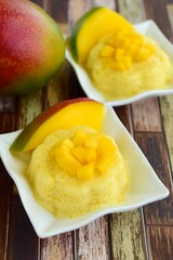Mango pudding with cubed fresh mango on top