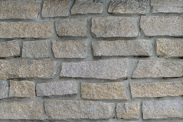 natural stone masonry using cement. textured natural surface. Front wall of the building, stone trim with ragged edges 