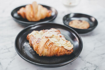 Close-Up Of Croissant Served In Black Plate , Fresh Baked Croissants. Warm Fresh Buttery Croissants and Rolls. French and American Croissants