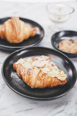 Close-Up Of Croissant Served In Black Plate , Fresh Baked Croissants. Warm Fresh Buttery Croissants and Rolls. French and American Croissants