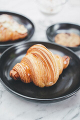 Close-Up Of Croissant Served In Black Plate , Fresh Baked Croissants. Warm Fresh Buttery Croissants and Rolls. French and American Croissants